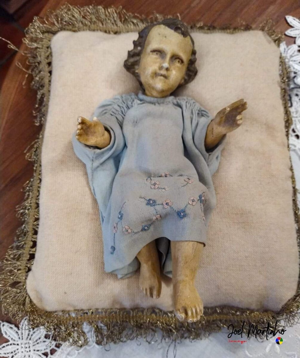 Menino Jesus antigo sobre almofada com franja dourada, túnica bordada